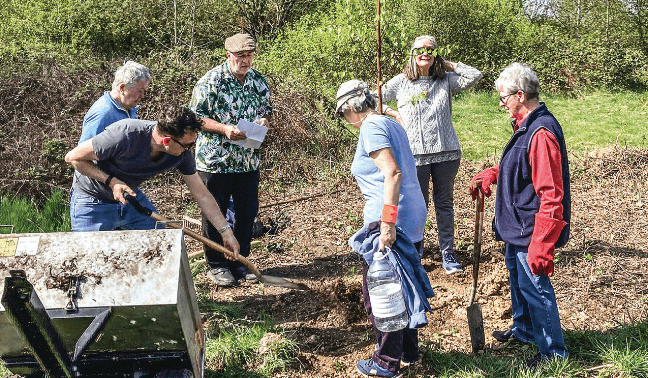 Stand sentinel: Volunteers plant the silver birch in honour of their friend Wayne Armsby, with his wife Elsie second from the right. Photo John Lawrence